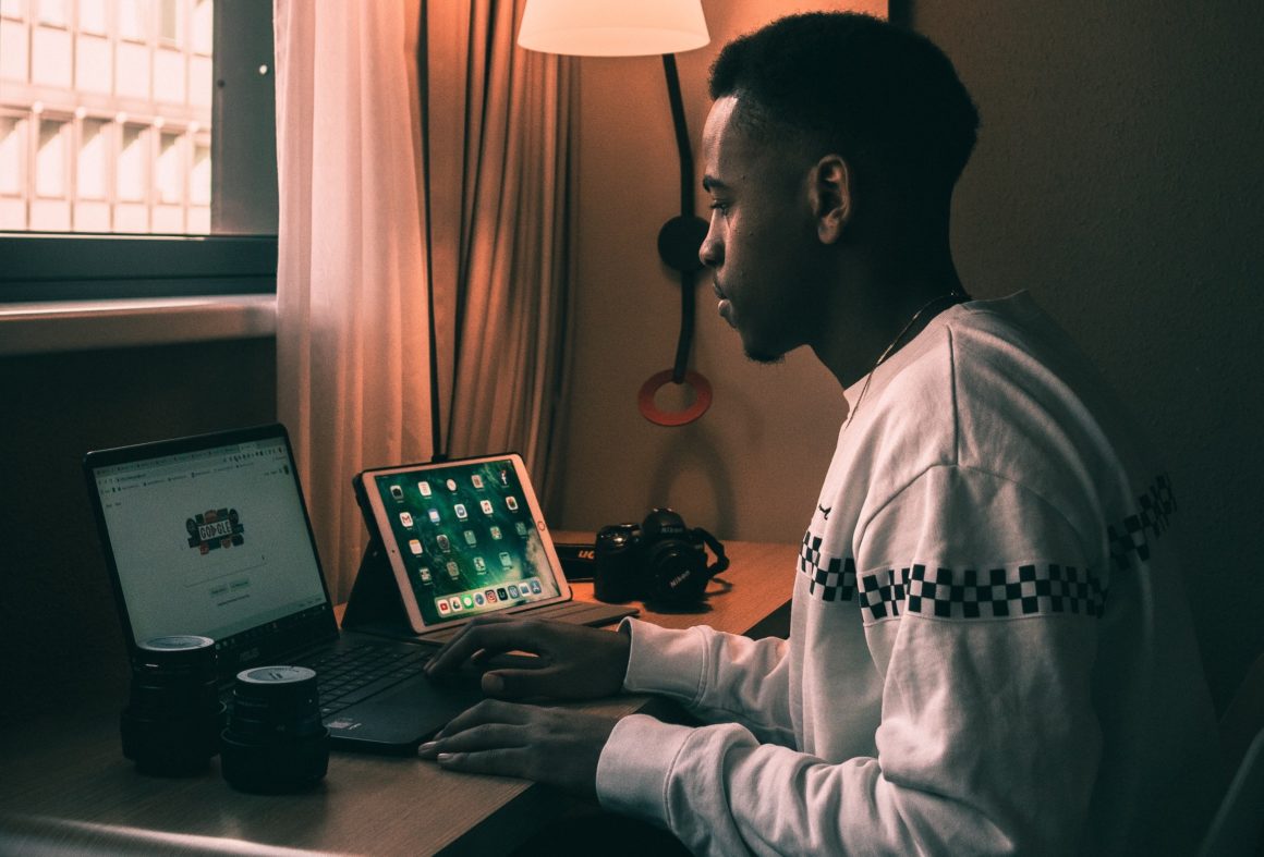 man using laptop and an ipad